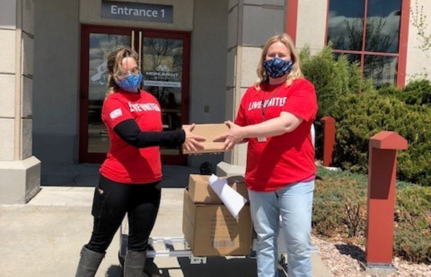 United Way of Black Hills representative Audrea Amstutz (left) joins ASI employee Melissa Hurley for a supply donation. 