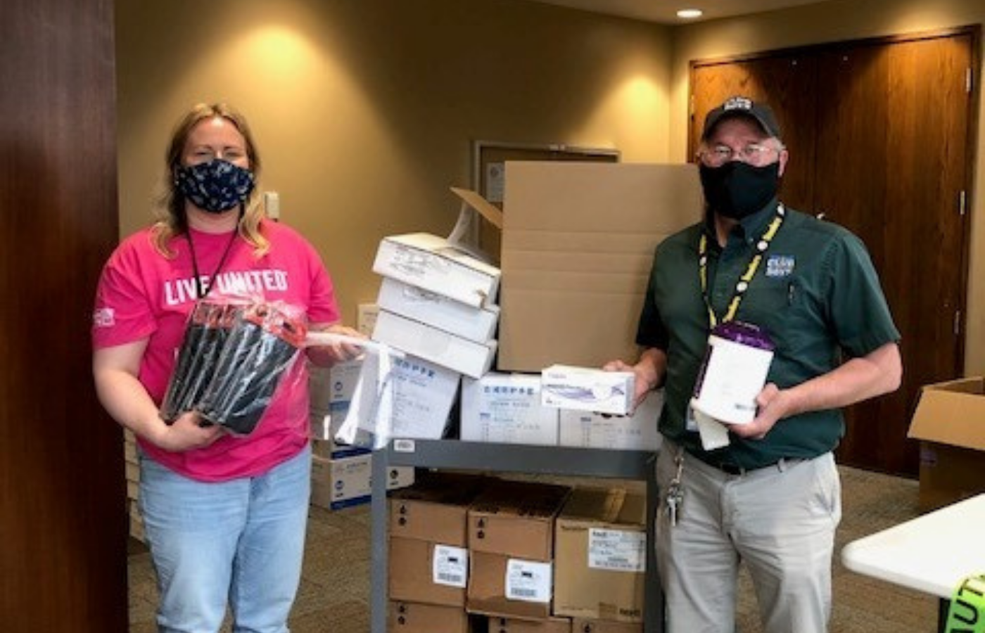 ASI employee Melissa Hurley (left) joins a representative from Rural America Initiatives for a supply donation. 