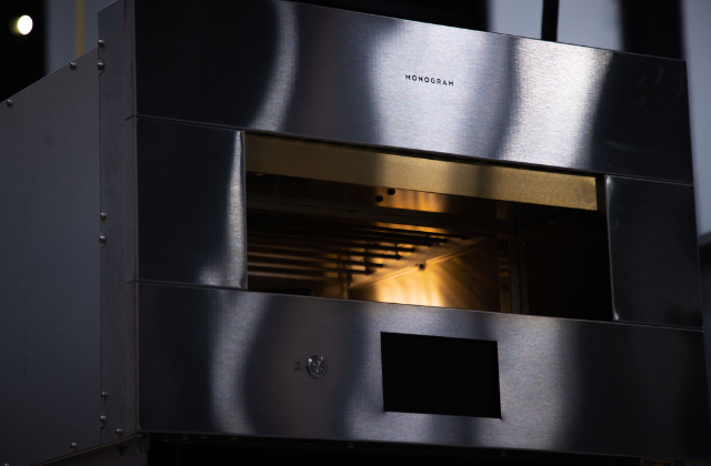 A nice static image of the Monogram Hearth Oven. The stainless steel on the appliance shines with the Monogram logo on the front